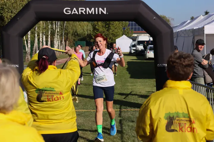 Célba érő futónő a Garmin kapunál, érmet kap